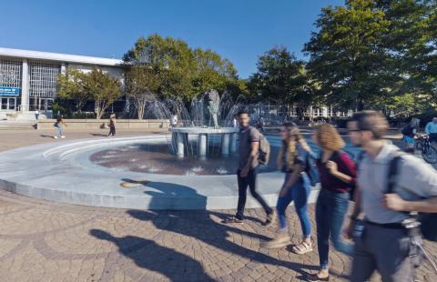 Students walking by Monarch fountain